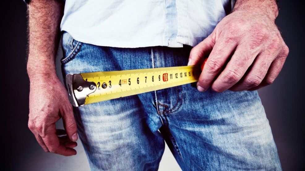 a man measures his penis after an increase in gel
